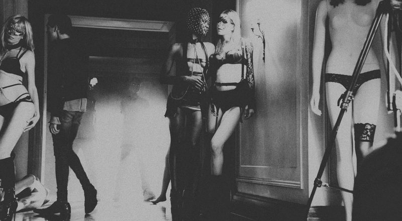 2 women half naked against the wall